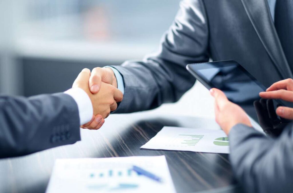 Too good to be true - deal completed so shaking hands - Carenza Commercial Investments