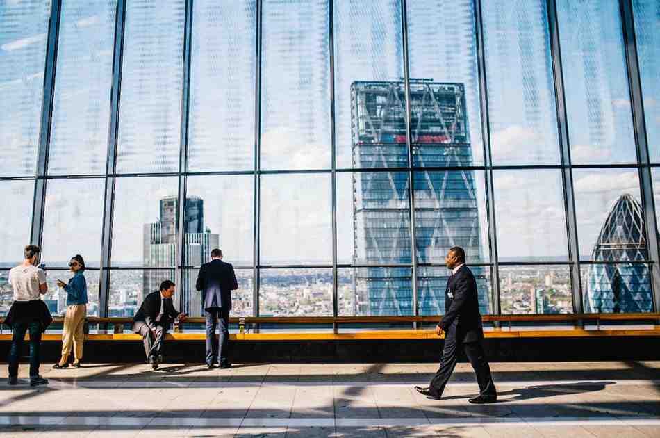 experienced investors - 1 profession walking along hiss building - Carenza Commercial Investments